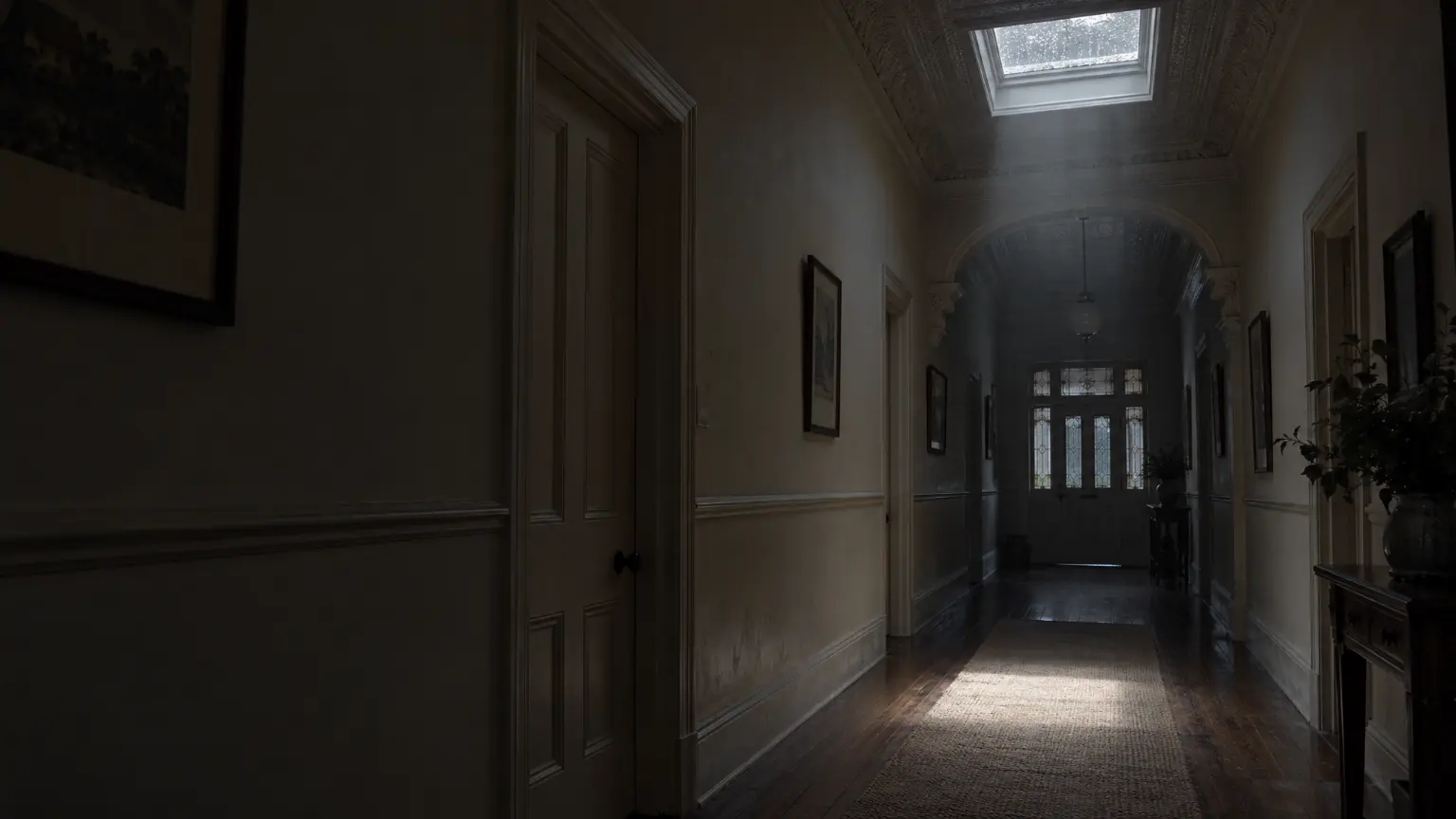 A villa hallway on a rainy day, daylight falling from a new skylight onto the floorboards.