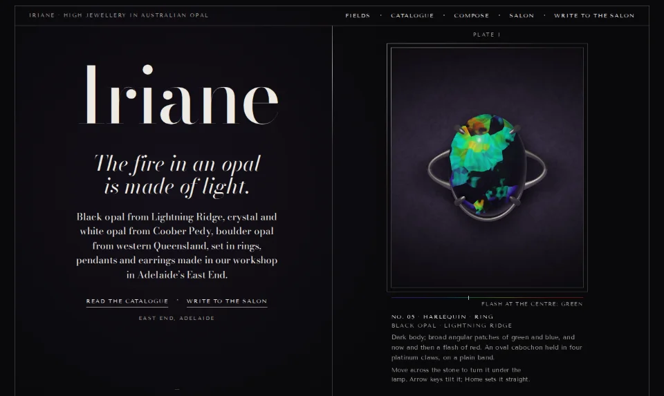 Iriane's front page: a black-opal ring lit from above in a framed plate, the name in a high-contrast serif
