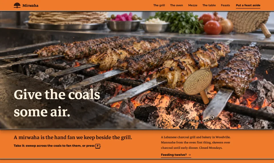 The front page: a woven hand fan held over glowing charcoal and skewers, sparks lifting, the headline low on the trough's dark lip above an orange band