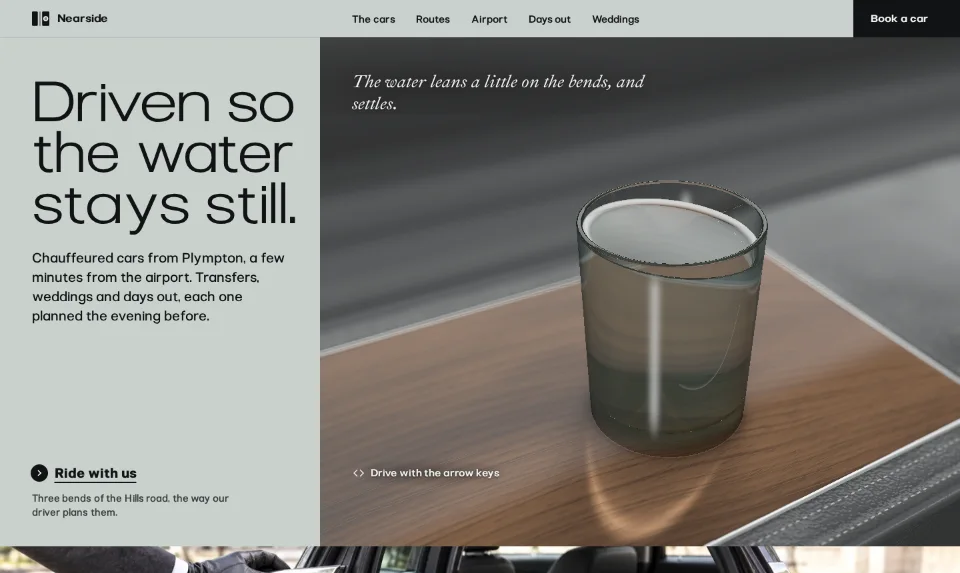 The front page: the headline in a wide grotesque on pale pewter, beside a glass of water standing on the walnut lid of the rear armrest