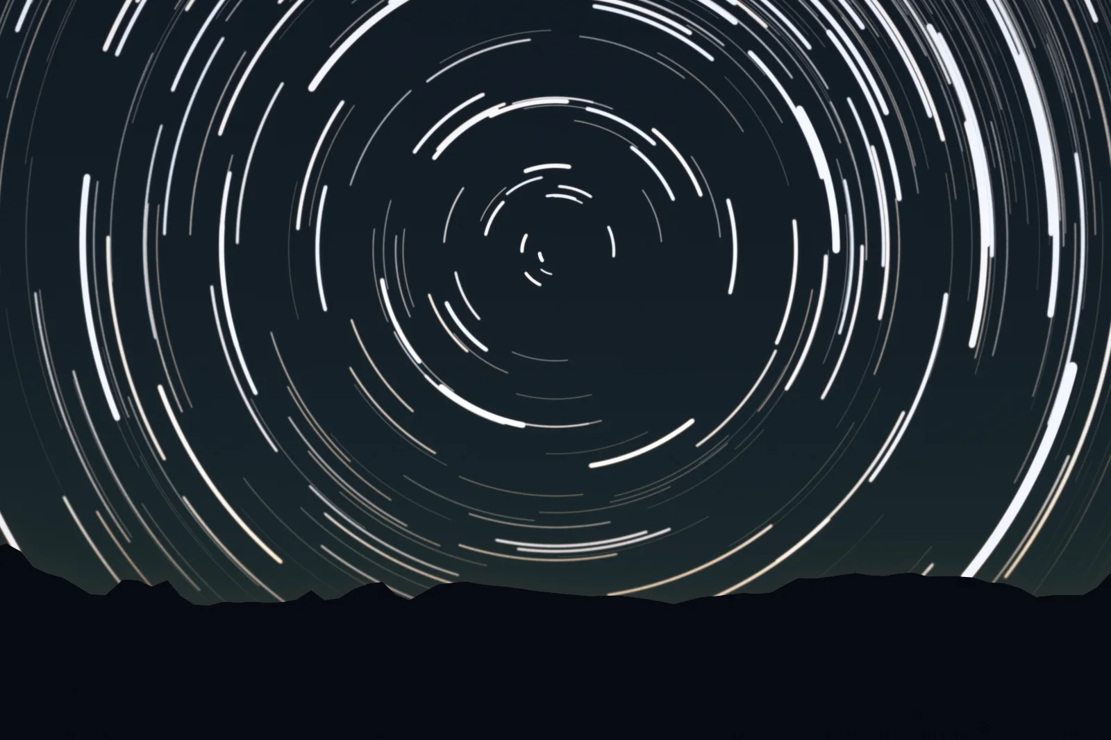 Star trails turning round the south pole of the sky above the ridge: a two-hour exposure.