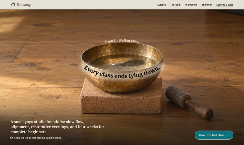 The front page: a hammered brass bowl on a cork block, its water ringing, a line of serif bent round its rim