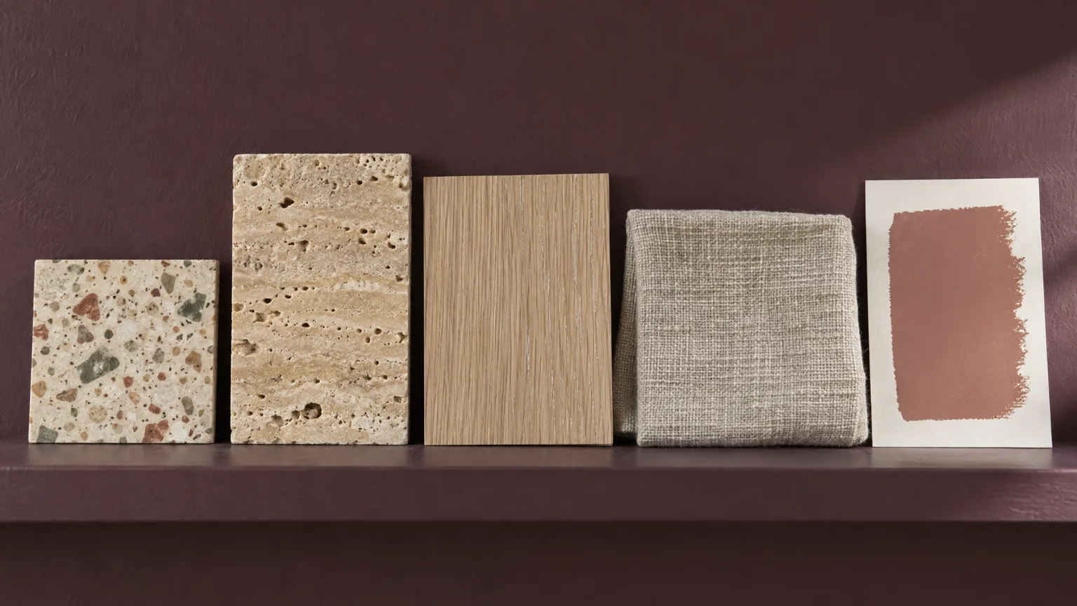 Five samples for a living room on a shelf: terrazzo, travertine, rift-sawn oak, linen and a clay-pink paint card