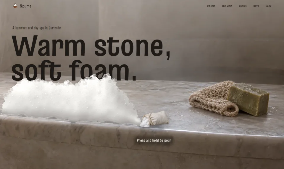 The front page: Warm stone, soft foam in wide letters sinking into white foam on a marble slab
