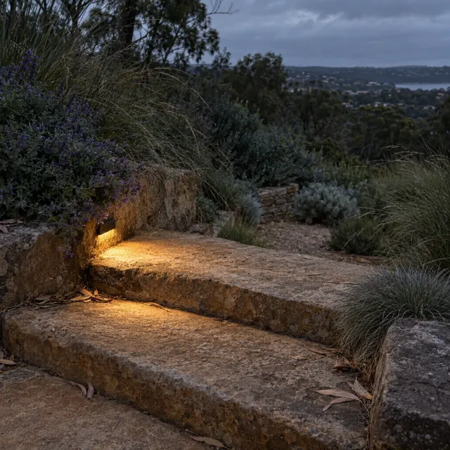 A warm pool of light on a sandstone tread