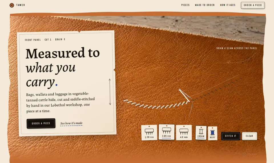 The front page: a raking-lit tan leather panel on the bench, a stitched seam across it and a cream paper pattern holding the headline