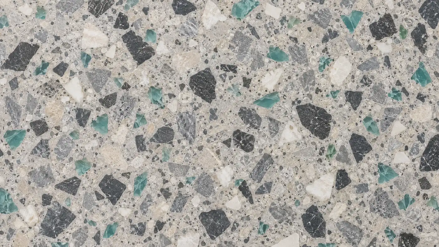 A bathroom floor in plan: honed terrazzo tiles, charcoal, white, steel-grey and a few jade chips in a pale grey matrix, set out from a laser cross on the waste